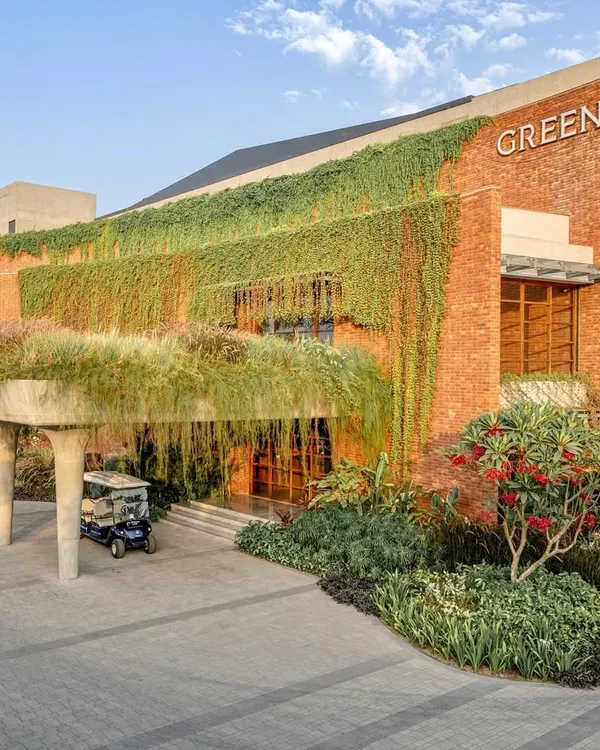 For the Greenlab diamond factory in Surat, I designed a landscape that completely transforms the building's brick facade. The cascading greenery and lush entrance create a welcoming environment, proving that industrial spaces can be green and vibrant.