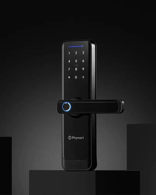 A clean example of product and utility. This hero shot for Phynart's smart lock uses a dark, moody background and focused lighting to highlight its sleek design and glowing fingerprint sensor.