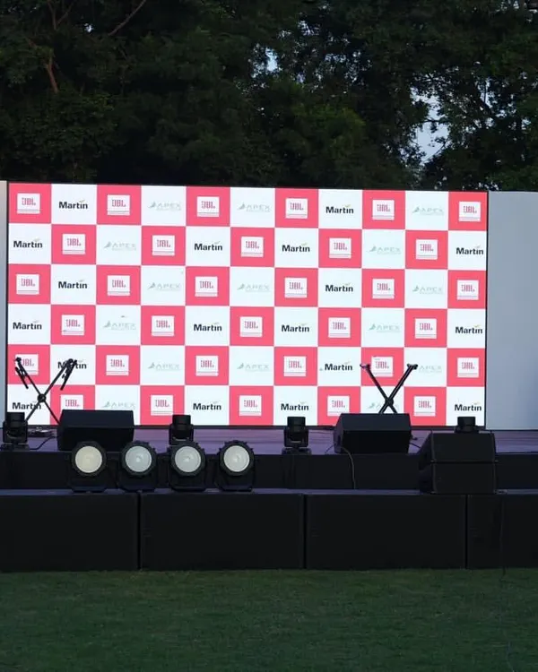 The complete stage setup for the 'Sound That Matters' corporate event in Delhi, ready for the show. This includes a custom-branded LED backdrop, stage monitors, and a full lighting rig.