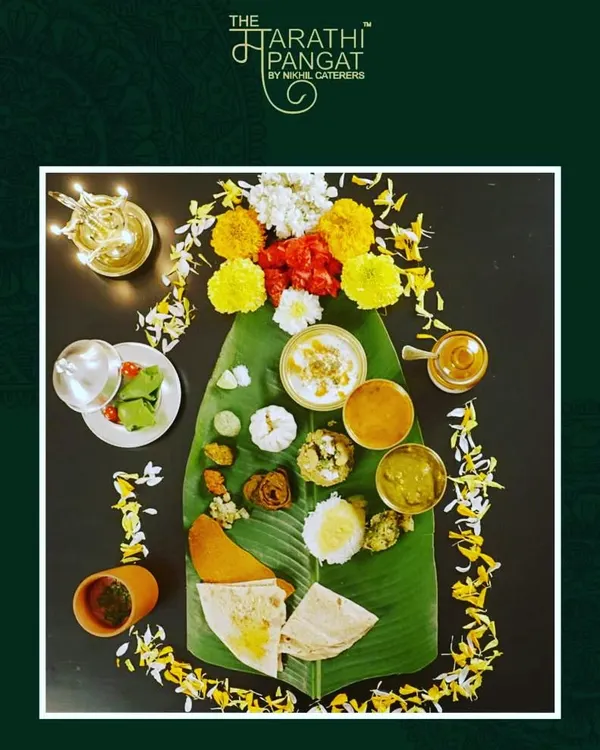 The 'केळीच्या पानावरची पंगत' symbolizes the simplicity and rootedness of Marathi culture. Serving food on a banana leaf is not just tradition; it is believed to enrich the food with nutrients and antioxidants, a healthy practice from our ancestors.