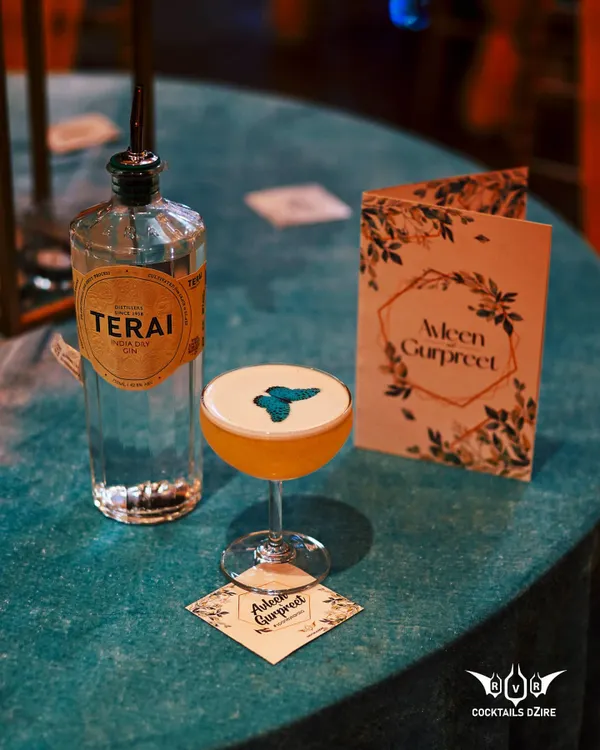 A truly bespoke cocktail created for a couple's special day. This drink features a custom edible print on the foam, served on a personalized coaster next to their wedding invitation.