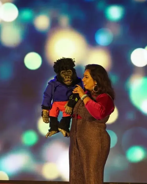 This is what pure joy looks like. On stage with Nikki, microphone in hand, sharing a laugh with the audience. This is my happy place, and I love making it yours too, whether it's for a corporate event or a college show.