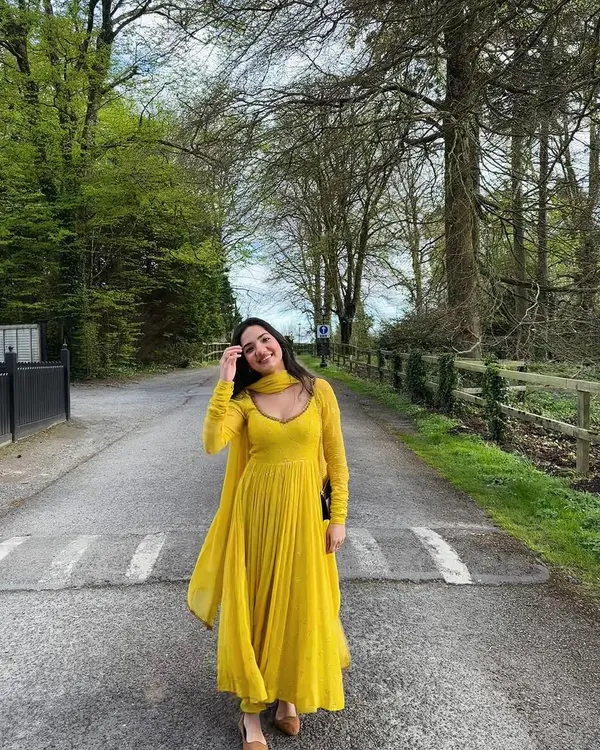 A client looking radiant in our yellow corset anarkali churidar set. Made from self-embroidered georgette, it is intricately highlighted with Dabka embroidery for a touch of tradition.