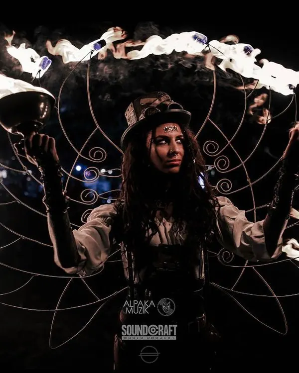We craft wearable art that becomes an extension of the performer. Here, our custom-made steampunk fire fans create a halo of flames, blending mechanical design with ethereal performance for a truly memorable visual spectacle.