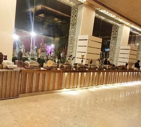 A wide view of a sleek, modern buffet counter designed for a large corporate conference. The clean lines and integrated lighting create a sophisticated and professional look.