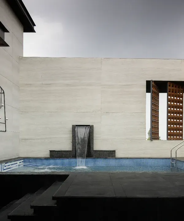 The rooftop swimming pool at The House of Dancing Screens is a luxurious centerpiece. It is flanked by a terrace garden and dynamic screens, and extends seamlessly into a spacious family lounge and entertainment area.