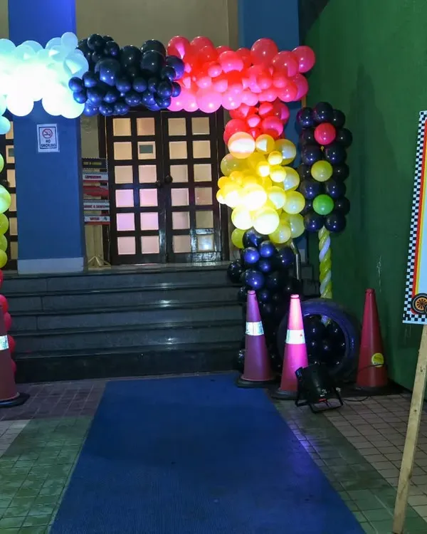 Ready, Set, Go! The entrance to a Ferrari-themed 5th birthday party, complete with a balloon arch, traffic cones, and a welcome sign to get the little racers excited.