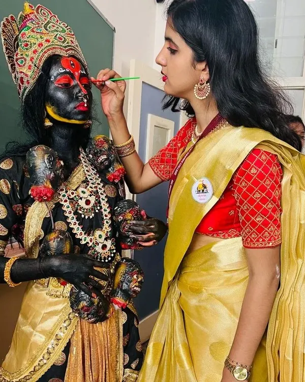 Here I am applying the intricate facial details for the Goddess Kali. This requires a steady hand and a deep understanding of how makeup transforms a person into a character.