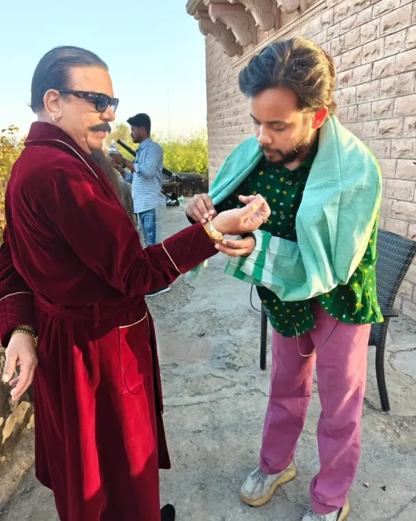 On-set adjustments are a huge part of my job. Here, I'm fitting a bracelet on Govind Namdev ji just before his shot to ensure every single detail of his 'don' character is perfect.