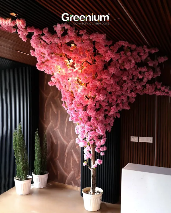 This magnificent artificial Cherry Blossom tree is a showstopper. Its vibrant pink blossoms and dramatic shape make it the perfect centerpiece for a hotel lobby, restaurant, or high-ceilinged home.