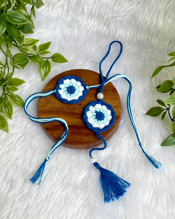 This is a custom Evil Eye Rakhi and Lumba set I made. The evil eye design is meant to offer protection, making it a thoughtful and meaningful gift for Rakshabandhan.