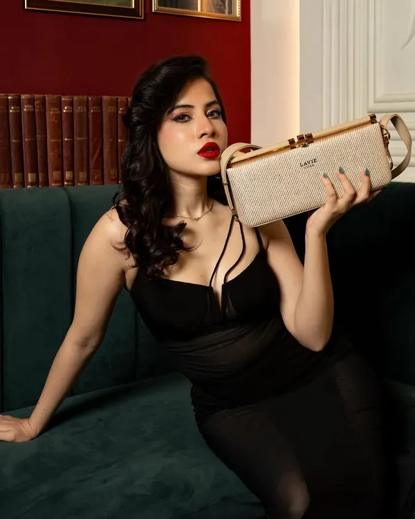 A campaign shot for Lavie handbags featuring influencer Uorfi Javed. Her pose is directed to prominently display the clutch, making it the hero of the image while maintaining a glamorous feel.