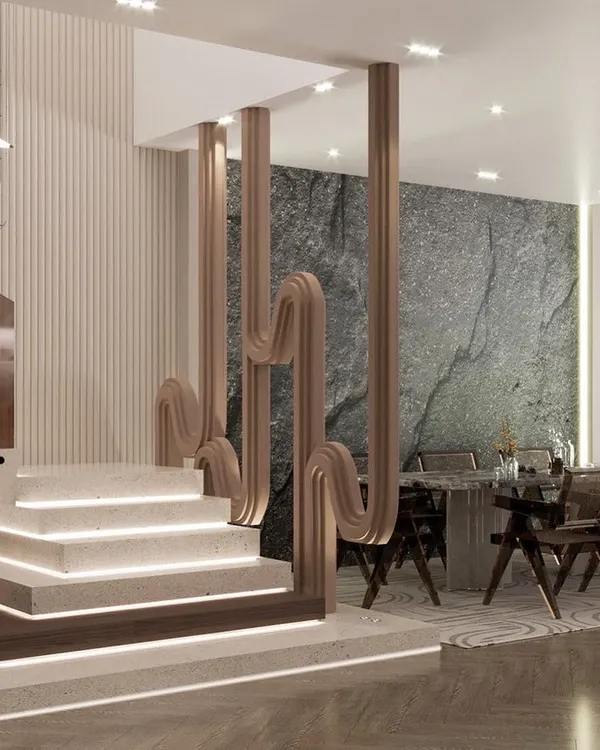 This perspective shows how the statement staircase integrates with the adjacent dining area. The sculptural partition element creates a visual separation while maintaining an open feel, and the raw stone accent wall adds a layer of natural texture to the modern space.