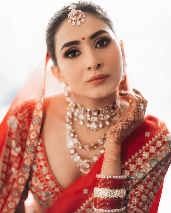A stunning close-up of the bride, showcasing her flawless makeup and exquisite jewelry. I use soft, natural light to highlight her features and create a classic, elegant portrait.