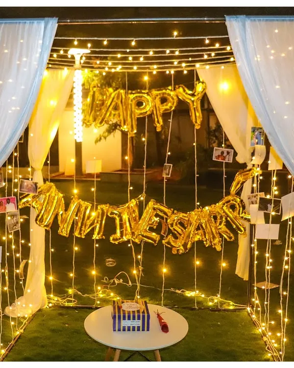 Our classic anniversary cabana is a world of its own. We use a sturdy frame draped with elegant white curtains and fill the space with fairy lights and "Happy Anniversary" balloons for a truly immersive romantic experience.