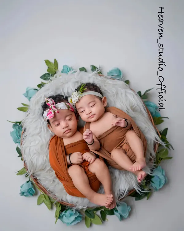 Double the joy, double the love. This portrait of twin newborns, nestled together in a floral wreath, is a beautiful testament to their special bond from the very beginning.