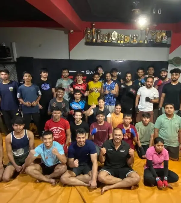 The spirit of our team is our greatest shield. A group photo capturing the energy and camaraderie of our students and coaches at the gym.