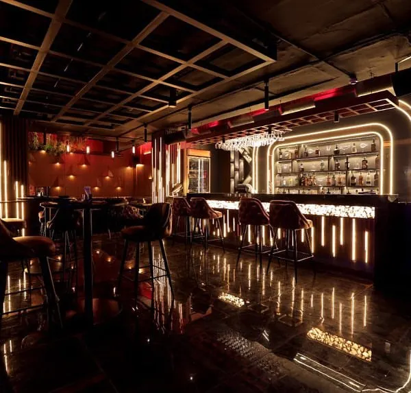 A view of the bar at Harmony Inn, where we installed a complete lighting automation system. The dynamic Hybec lighting, controlled by a Wiser system, creates a sophisticated and inviting atmosphere for patrons.
