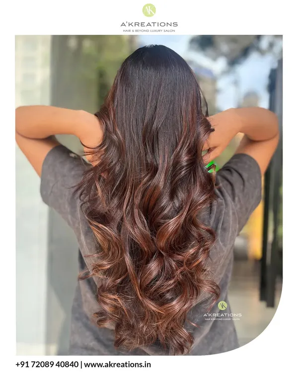 A beautiful example of a rich brown color melt, styled into glossy, soft waves. This look adds depth and movement, creating a truly luxurious feel.