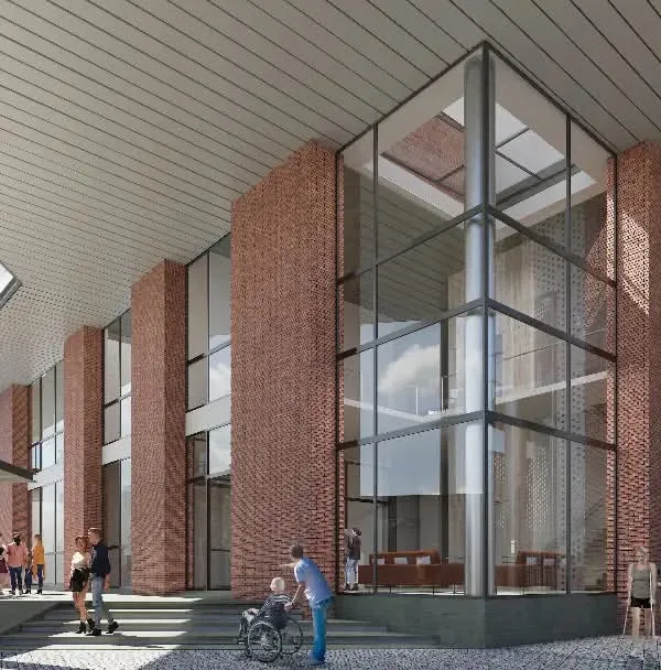 The entrance to the KMYF Rehabilitation Center is designed to be both welcoming and inspiring. The rising volumes of brick and glass, combined with a perforated metal screen, create a dynamic interplay of solid and void. This design provides filtered light and a sense of arrival, setting a hopeful tone for a space dedicated to healing.