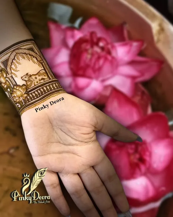 Simplicity speaks serenity. This minimal wristband design featuring a cow and lotus flowers is a perfect example of how a small, meaningful design can be incredibly beautiful.
