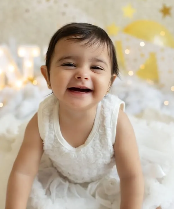 And look who's all smiles on her birthday! This is the moment just before the cake comes out, full of excitement and joy in our "Twinkle Star" setup. Her happy grin is just priceless.