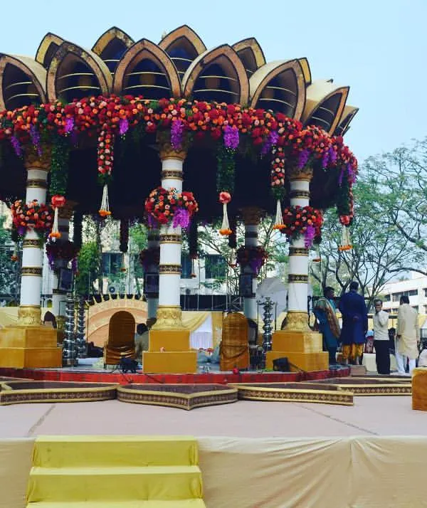 This stunning outdoor lotus-petal mandap is a masterpiece of luxury wedding decor. The combination of the unique structure, heavy floral work, and grand scale makes for an unforgettable ceremony.