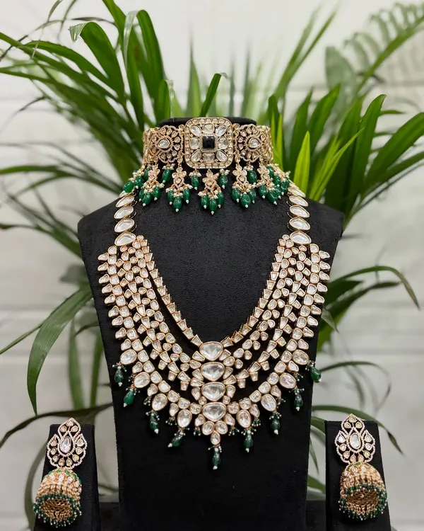 This is one of our most popular full bridal rental sets, featuring a Kundan choker, a magnificent multi-layered rani haar, and matching jhumkas with emerald green beadwork.