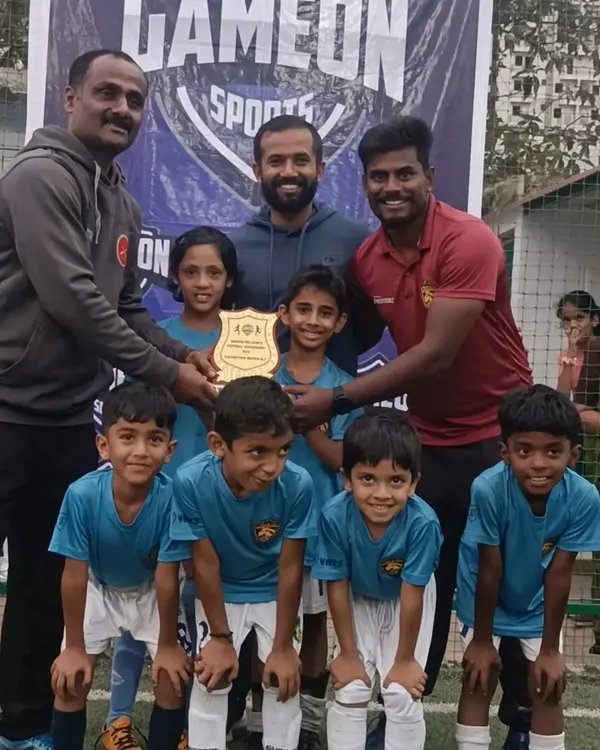 Our U-7 football team celebrating with their trophy after a dominant 6-0 win in an exhibition match against Gameon Sports.