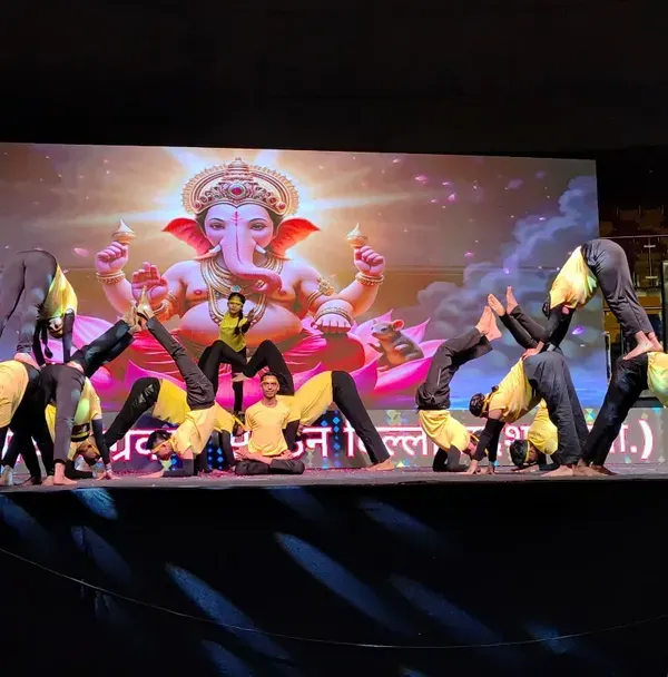 A dynamic moment from my students' performance at Talkatora Stadium. This complex pose demonstrates the advanced acrobatic yoga skills and teamwork we cultivate.