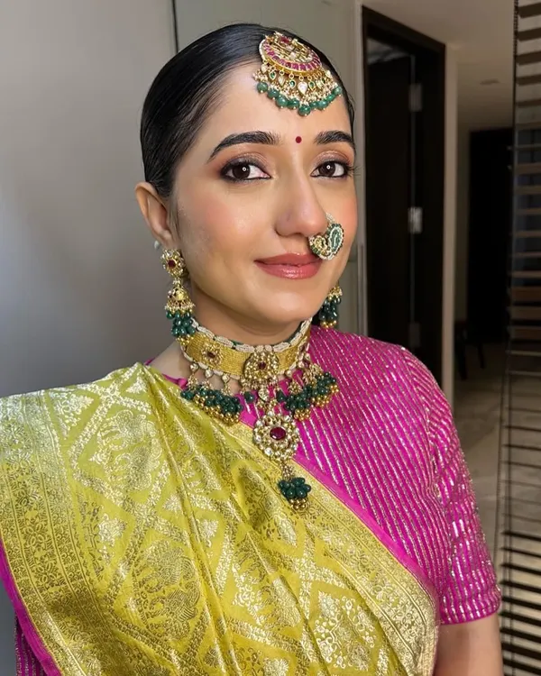 For Archi, we embraced simplicity with this beautiful Gujarati-style look. The makeup is clean and minimal, with a defined eye and a traditional bindi, perfectly complementing her vibrant silk saree.