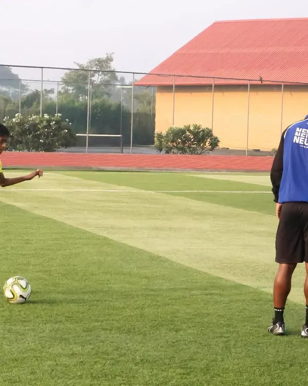 A NorthEast United FC coach provides personalized guidance to a young player at our Residential Academy. This demonstrates the hands-on, expert instruction our students receive as part of our ISL club partnership.