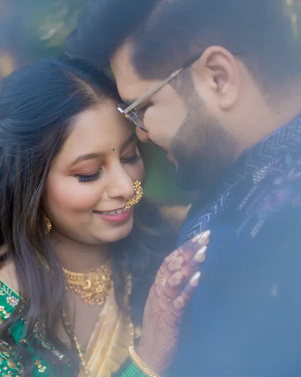 A soft and dreamy close-up, capturing a quiet, intimate moment between the couple on their wedding day.