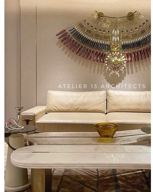 A different perspective of the lounge with the KLOVE STUDIO glass necklace, focusing on the statement marble coffee table with bronze legs. This view shows how we layer different shapes, materials, and finishes to create a cohesive design.
