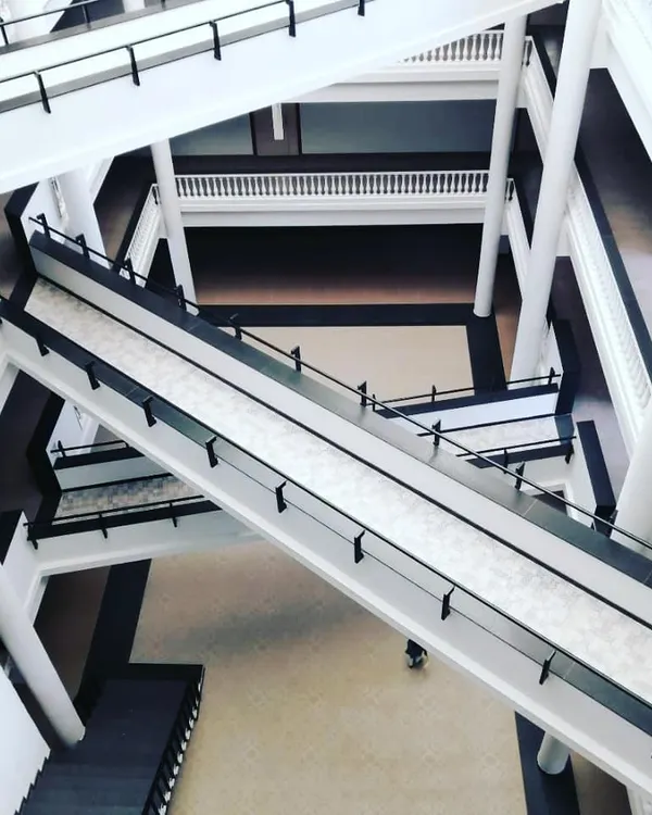 The bridge network inside an ongoing institutional project in Bengaluru. This system of zigzagging bridges creates dynamic visual communication and physical connectivity between different departments across a multi-story atrium.