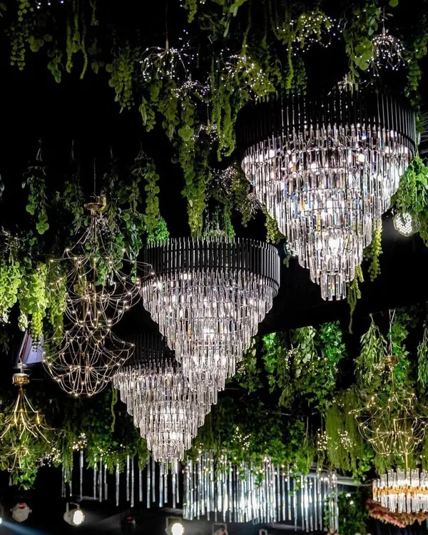 We create breathtaking ceiling installations that transform a venue. Here, magnificent crystal chandeliers are suspended among hanging greenery, creating a magical, forest like canopy for a truly enchanting gala dinner.