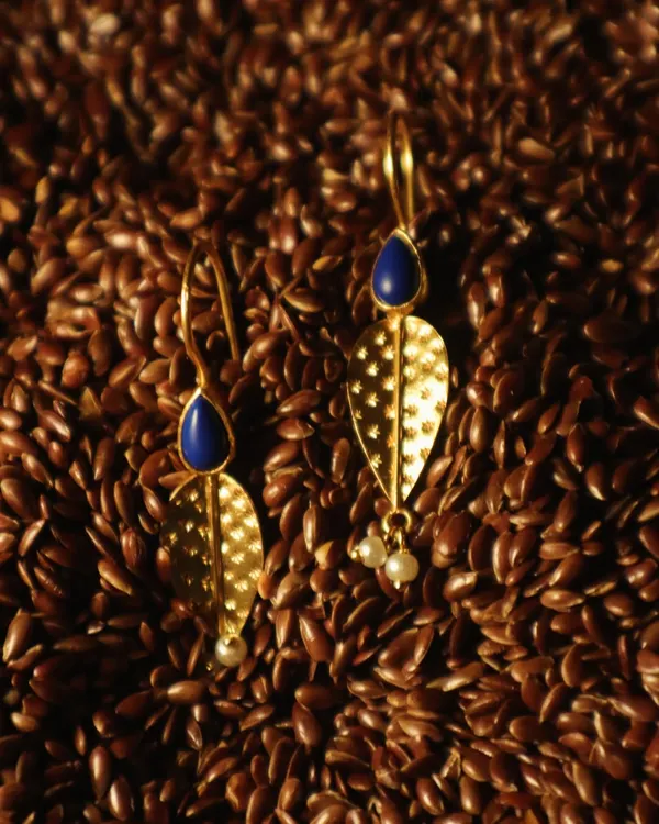 Lapis, gold, and pearls come together in these earrings, mirroring the fullness of a new season. They are crafted from sterling silver with 18k gold plating.