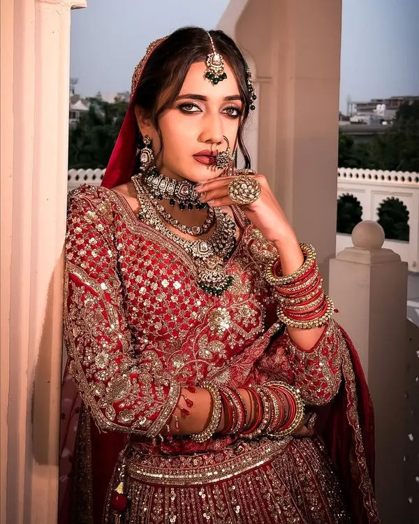 A close-up of our royal bride in red. The focus here is on creating a powerful statement with defined, kohl-rimmed eyes and flawless skin that glows under any light.
