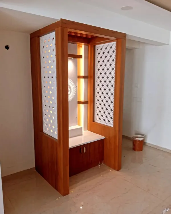 We crafted this custom pooja unit, applying a rich, warm wood polish that highlights the natural grain. The finish protects the wood while accentuating the detailed jali panels and integrated lighting.