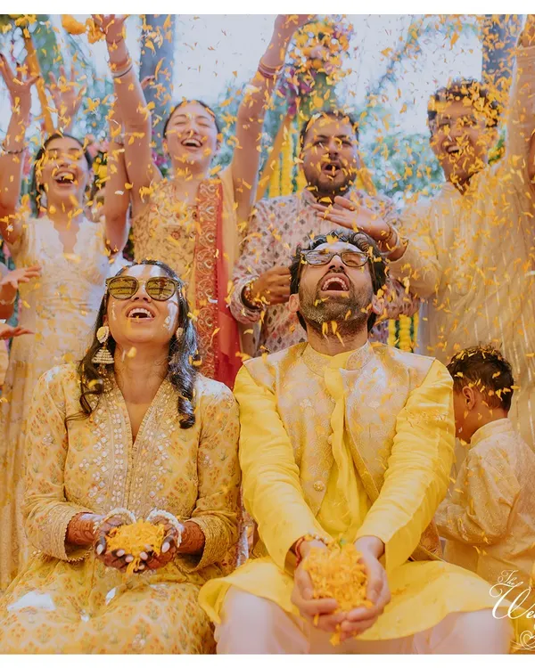 The quintessential "phoolon ki haldi" shot. I ensure these moments are not just chaotic fun but also beautifully captured, surrounded by friends and family.