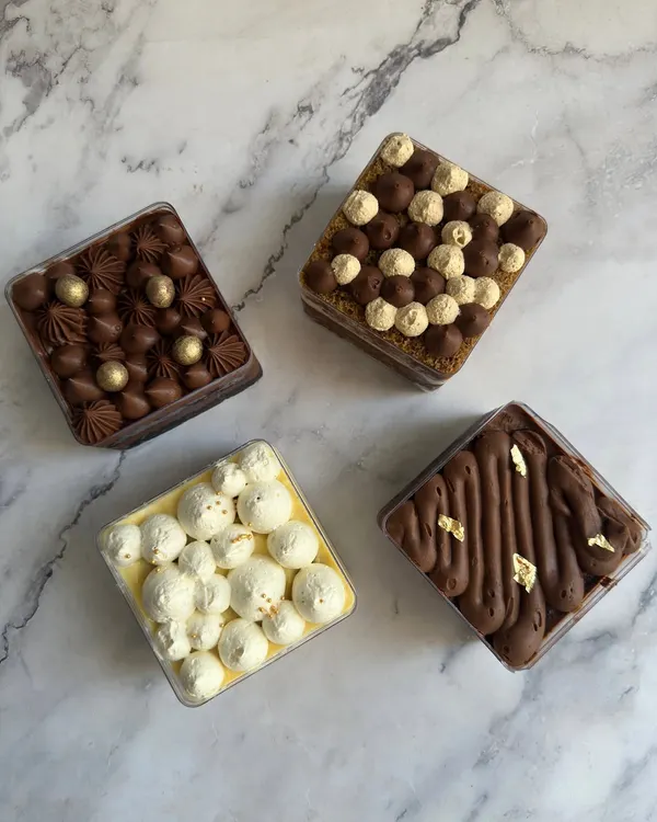 My dessert tubs are perfectly portioned treats made just for one. This assortment shows four different flavors, including a rich chocolate tub and a light lemon meringue tub.