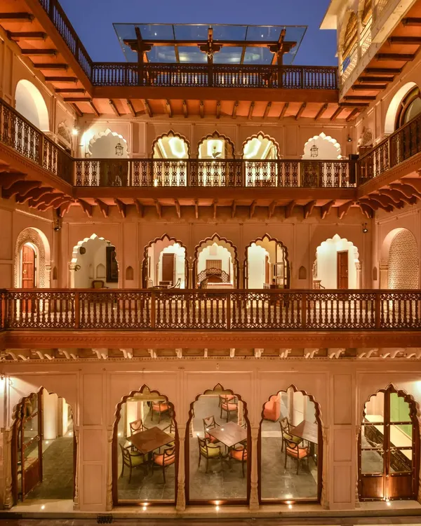 The central courtyard of Haveli Dharampura, viewed at dusk. The inward-looking design, a hallmark of Mughal havelis, ensures that every level is visually connected, creating a sense of community and shared experience. This project received the UNESCO Asia-Pacific Award for its cultural heritage conservation.
