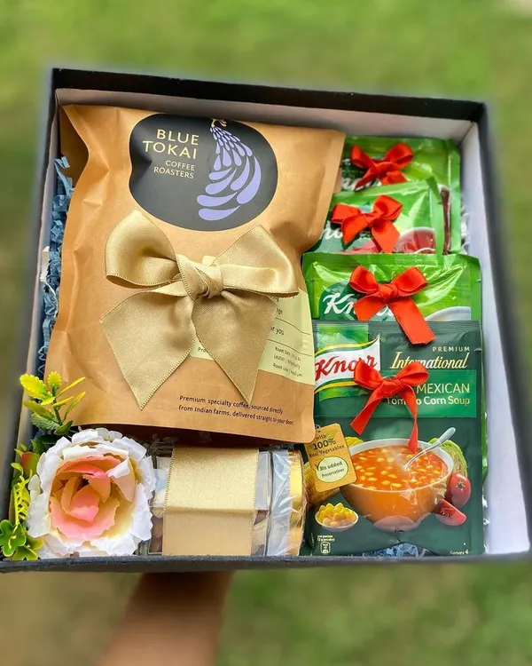 This "We Care" hamper is designed to offer comfort and warmth. It includes premium Blue Tokai coffee, nourishing Knorr soup packets, and a sweet treat, making it a perfect gesture to show support for a colleague.