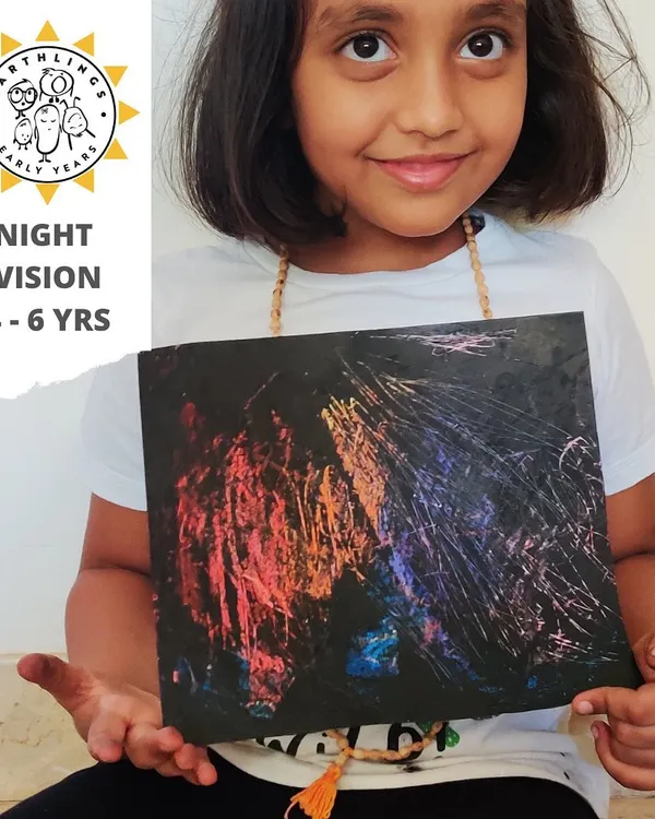 This proud artist is showing off her "Night Vision" creation. This scratch art activity simulates how nocturnal animals see in the dark and is a fun way to explore color, texture, and jungle themes.