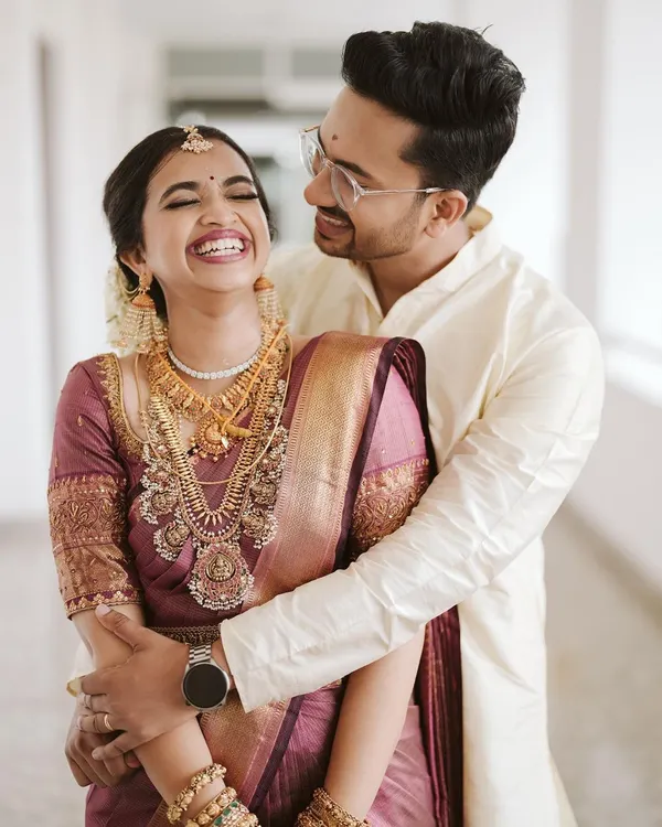 The pure, unadulterated joy of a wedding day. Namritha's laughter is infectious as she is embraced by her groom, Nandakishore, during their beautiful Kerala wedding.