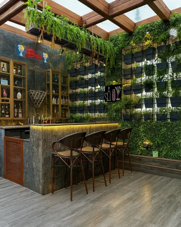 We believe every space has the potential to be a masterpiece. Here, we transformed a bar area into a lush, inviting retreat with a full-scale living wall and custom lighting, creating an unforgettable ambiance.