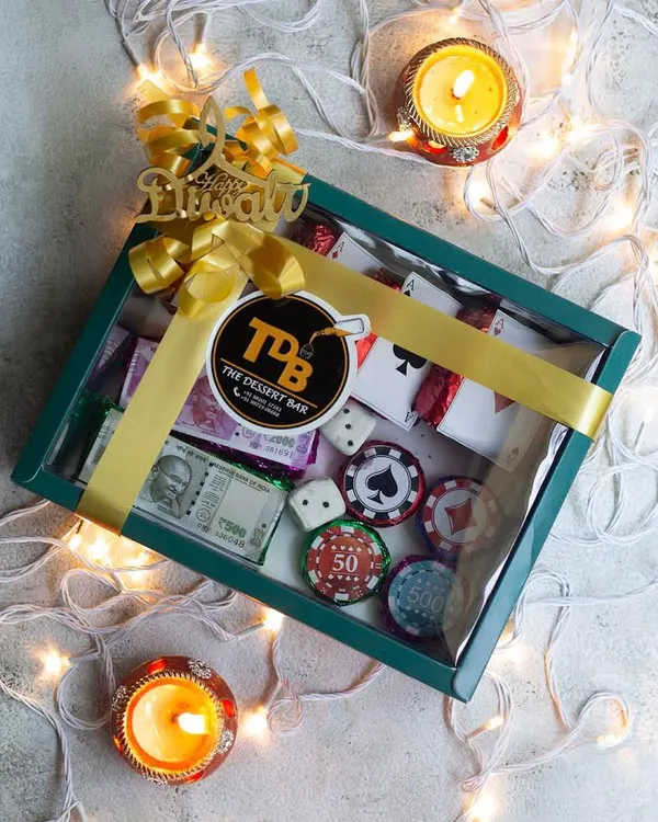 Get ready for your Diwali party with my edible Poker Set hamper. This creative gift box includes fudgy brownie playing cards and chocolate-enrobed biscuit poker chips, perfect for a night of fun.