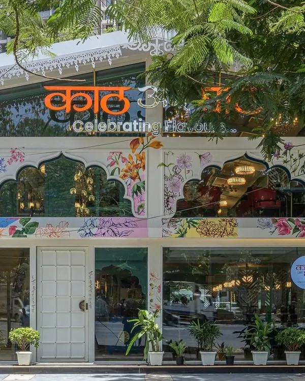The entire facade of this restaurant is a hand-painted celebration of Maharashtra's native foliage. I blended colorful bougainvillea, seasonal Jarul, and other local flora with traditional architectural shapes to create a vibrant and welcoming entrance.