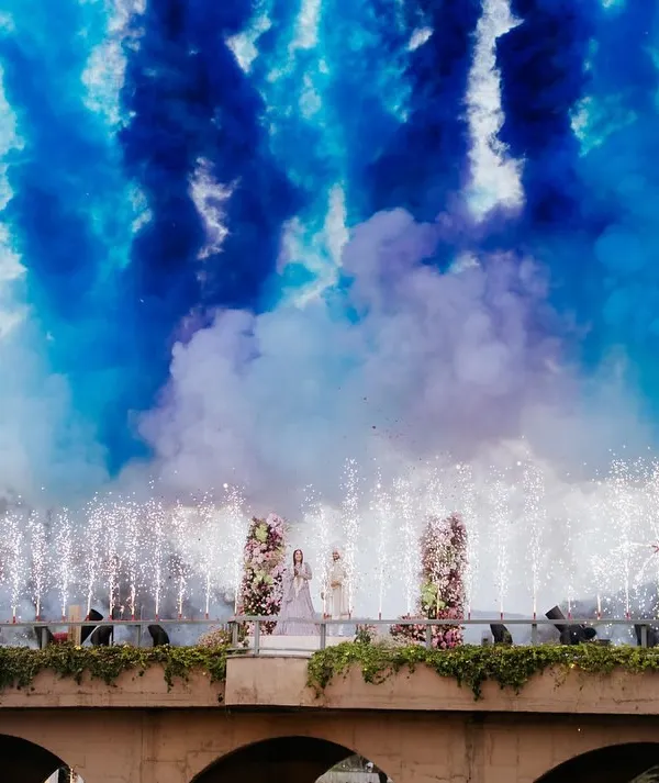 A spectacular varmala moment, where love is celebrated with a burst of color and pyrotechnics over a scenic bridge. This is how we turn a sacred ritual into a breathtaking, cinematic memory.