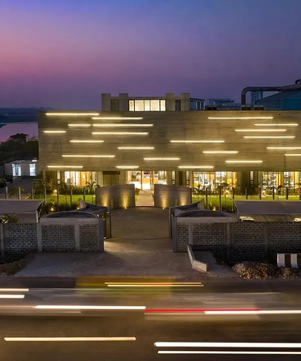 This is our design for the Laxcon Steel Plant Office in Ahmedabad. The linear lighting integrated into the ribbed concrete facade is inspired by the streaks of light from traffic on the adjacent highway, creating a building that is in constant dialogue with its surroundings.